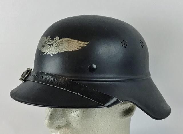 WW2 German Luftschutz Helmet: World War Two German Luftschutz Helmet. Steel construction with beaded body and rolled rim, four ventilation holes and three split pins. Front bears winged "LUFTSCHUTZ" decal, interior rim with maker 