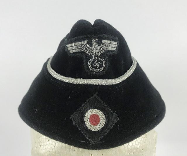 WW2 German Heer Panzer Officer Overseas Cap: World War Two German Heer Panzer Officer M1938 Overseas Cap. Black wool construction with machine applied two piece eagle over cockade insignia and braided silver bullion piping. Interior with grey tw