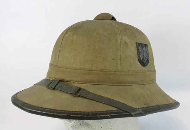 WW2 German Heer DAK Pith Helmet: World War Two German Heer Deutsches Afrika Korps pith helmet. Cork body with khaki canvas construction with vented top and leather rim. Metal Heer eagle shield insignia and National shield. Interior w