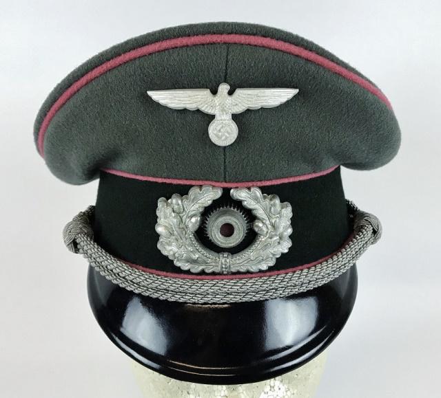 WW2 German Heer Named 2nd Panzer Officer Visor Cap: World War Two German Heer Panzer Officer visor cap. Quality grey-green wool construction with dark green band, pink piping, and black lacquered vulcanfibre visor. Braided silver bullion adjustable chi