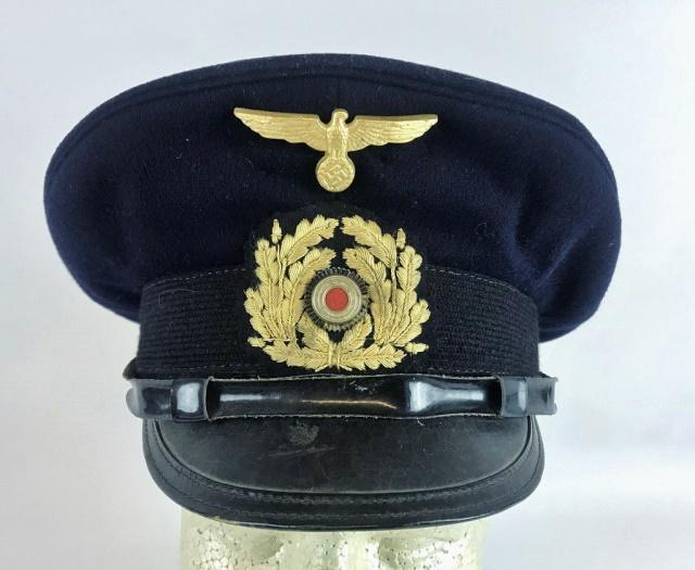 WW2 German Kriegsmarine NCO Visor Cap: World War Two German Kriegsmarine NCO visor cap. Navy blue wool construction with mohair band, adjustable leather chinstrap secured by two gilt fouled anchor buttons and vulcanfibre visor. Three piece
