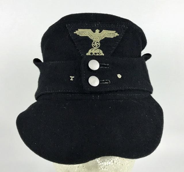 WW2 German SS Panzer EM / NCO Field Cap: World War Two German SS Panzer EM / NCO Field Cap. Black wool construction, earflaps secured by two magnetic pebbled buttons and additionally small Iron Cross spange pin and wreathed eagle pin. Hand a