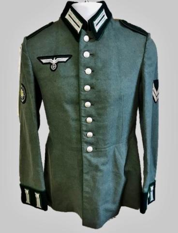 WW2 German Heer Jager NCO Parade Tunic: World War Two German Heer Jager NCO parade tunic. Quality green grey wool construction with green piping, eight button front closure, hooked collar, green piped cuffs with bullion litzen and silk line