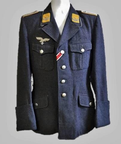 WW2 German Luftwaffe Flight Officer Field Tunic: World War Two German Luftwaffe Flight Officer M1935 field tunic, insignia denotes rank of 2nd Lieutenant. Constructed of blue grey wool with four pocket, four button front closure, French cuffs and la