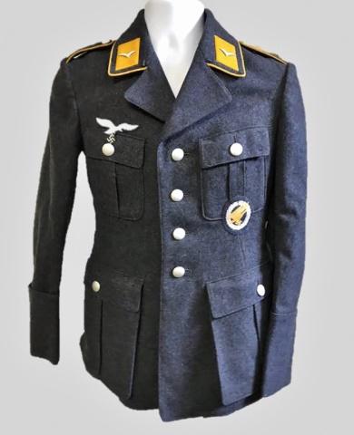 WW2 German Luftwaffe Fallschirmjager NCO Tunic: World War Two German Luftwaffe Fallschirmjager NCO M1935 field tunic, insignia denotes rank of Sergeant. Constructed of blue grey wool with four pocket, four button front closure, French cuffs and lay