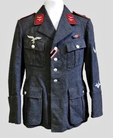 WW2 German Luftwaffe Flak Artillery NCO Tunic: World War Two Luftwaffe M1935 Flak Artillery NCO field tunic, insignia denotes rank of Lance Corporal. Constructed of blue grey wool with four pocket, four button front closure, French cuffs and lay d