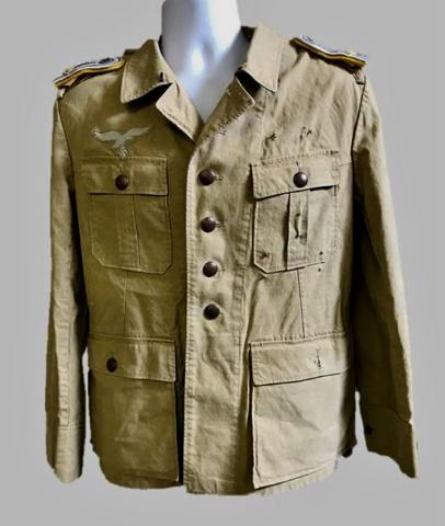 WW2 German Luftwaffe Flight Officer Field Blouse: World War Two German Luftwaffe Desert Airforce Officer field blouse, insignia denotes rank of 1st Lieutenant. Constructed of tan cotton twill, with four pocket, six button front closure, interior with