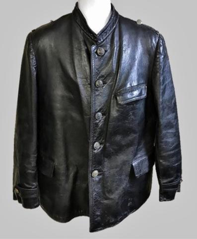 WW2 German Kriegsmarine Leather Deck Jacket: World War Two German Kriegsmarine Deck Jacket. Black leather construction with three pocket front and five button front closure with grey finished Kriegsmarine fouled anchor buttons, adjustable button
