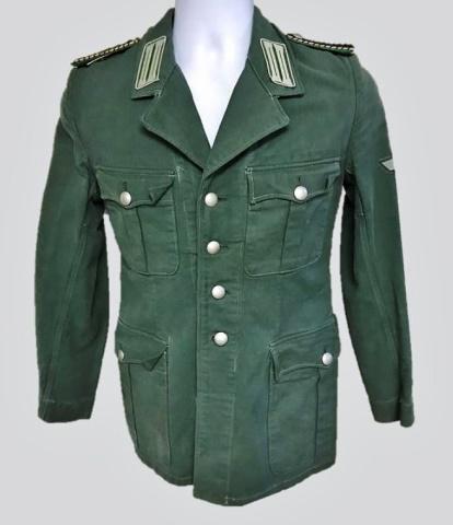WW2 German Schuzpolitzie Officer Field Blouse: World war two German Schutzpolizie Officer Summer field blouse, insignia denotes rank of Wachtmeister der Schutzpolizei. Blue grey cotton construction, four pocket front with four button front closure