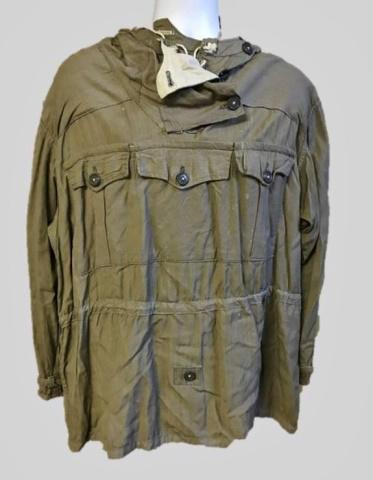 WW2 German Heer Gebirgsjager Reversible Anorak: World War Two German Heer Gebirgsjager Reversible Anorak. Constructed of tan cotton fabric reversible to white, three flap pocket front with two rear pockets, lace up neck with button flap closure, ho