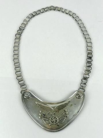 WW2 German Luftwaffe Standard Bearer Gorget: WW2 German Luftwaffe Standard Bearers Gorget. Plated metal with Luftwaffe eagle and flags device at center with two stylized bosses. Reverse with two clips, one marked "ASSMANN" (Assmann & Sohne) and