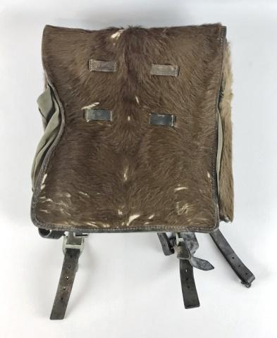 WW2 German Heer Tornister Backpack: World War Two German Heer Tornister Backpack. Constructed in leather with pony fur and leather carry straps with steel belt attachment clips. Interior canvas lined with leather closure straps. Good co