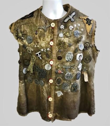 WW2 "Hate" Vest with War Souvenir German Insignia: World War Two "Hate" Vest with Souvenir German Insignia. Rabbit skin vest decorated with seventy diverse assorted combat badges, medals, awards, insignia and pins. Good overall condition with heavy we