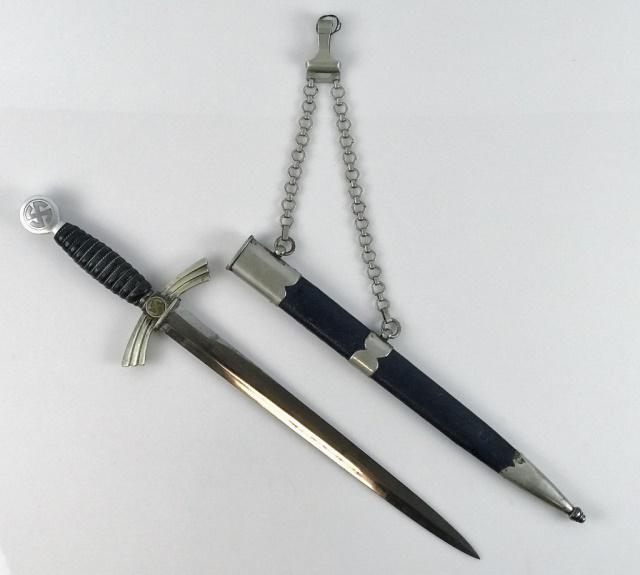 WW2 German 1st Model Luftwaffe Officer Dagger, SMF: World War Two German Luftwaffe Officer dagger. Bright steel blade with etched maker mark "SMF SOLINGEN" with logo. Silvered nickel wing form cross guard with gilt sun wheel swastika, mismatched pommel