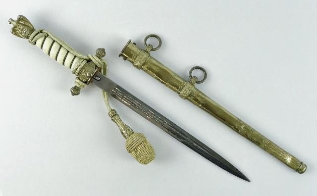 WW2 German Kriegsmarine Officer Dagger, WKC: World War Two German Kriegsmarine Officer Dagger. Double etched blade, decorated with dolphins, fouled anchor and foliate design, with stamped maker mark, "W K C" with knights head logo. Gilt brass fi
