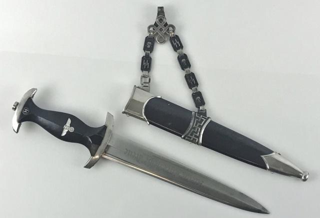 WW2 German SS Officer Chained Dagger: World War Two German M1933 SS Officer Dagger. Bright steel blade with deeply etched "Meine Ehre heist Treue" motto. Nickel plated fittings with ebony wood handle set with eagle and enameled sig rune b