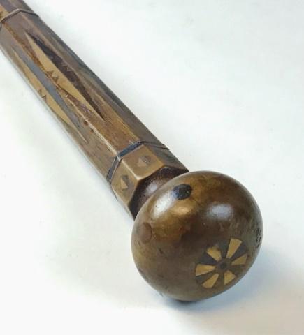 19th C. Sailor Made Inlaid Wooden Cane: 19th C. Sailor Made Inlaid Wooden Cane. Hand carved with two-stage octagonal to round shaft and knob top. Wood inlayed with geometric design in ebony and satin wood decoration, end capped with with br