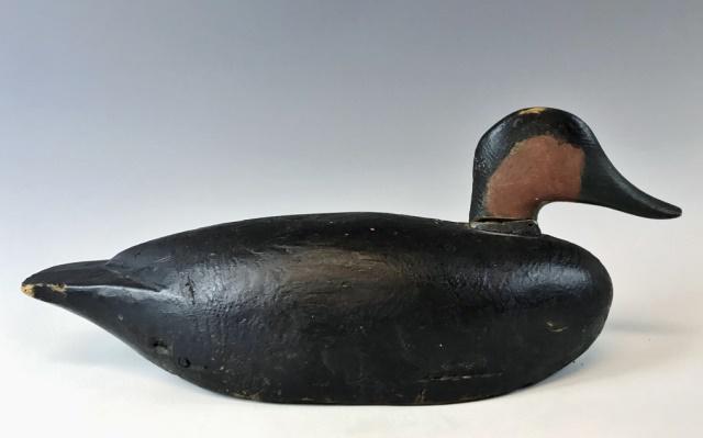 Antique South Shore Carved Wooden Black Duck Decoy: Antique Primitive Hand Carved and Painted Duck Decoy from Hingham, Massachusetts. Decoy in good field used condition with with rigging bail, gunning and repair at neck. Decoy measures: 19" L.