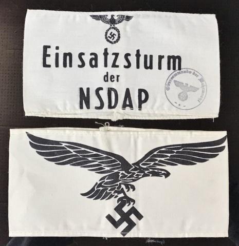 WW2 German Luftwaffe, Einsatzsturm Armbands, (2pc): Two World War Two German screen printed cotton armbands: (1) Sewn white cotton armband with Luftwaffe eagle clutching swastika, (1) Sewn white cotton armband reads, "Einsatzsturm der NDSAP" surmounted