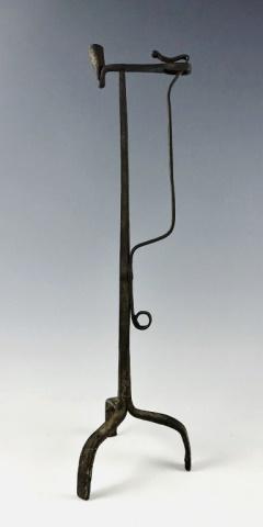 17th C. Wrought Iron Candle and Rush Light: 17th C. Wrought Iron Combination Candle and Rush Light. Hand forged light with tripod base, peened hand squeeze rush light clap and top bar with candle holder. Primitive construction attractive old ox