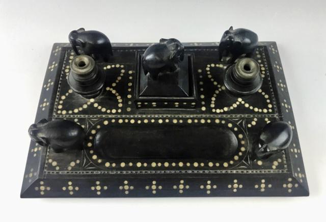 Anglo Indian Ebony Double Inkwell Desk Set: Antique Anglo-Indian Double Inkwell Desk Set. Crafted of carved ebony wood with bone inlay decoration and carved elephants. Double inkwells with center compartment. Excellent condition, measures: 10.5