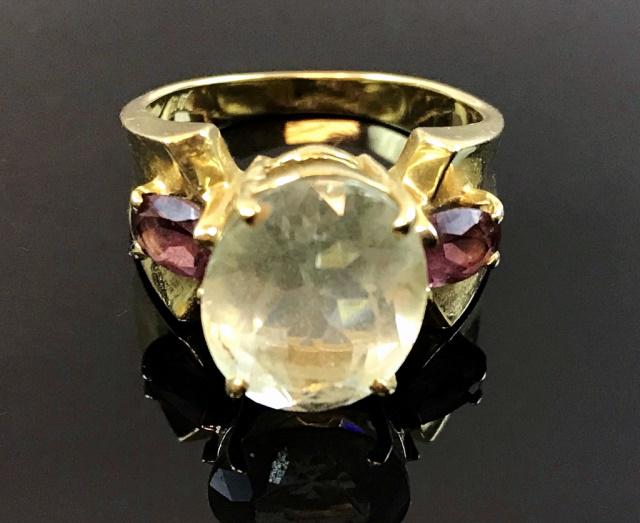 Ladies 14K Gold Aquamarine and Tourmaline Ring: Vintage ladies 14K gold, aquamarine and tourmaline ring. Crafted of 14K yellow gold with center prong set oval cut aquamarine stone flanked by two oval cut pink tourmalines. Ring size: 7, Total assemb