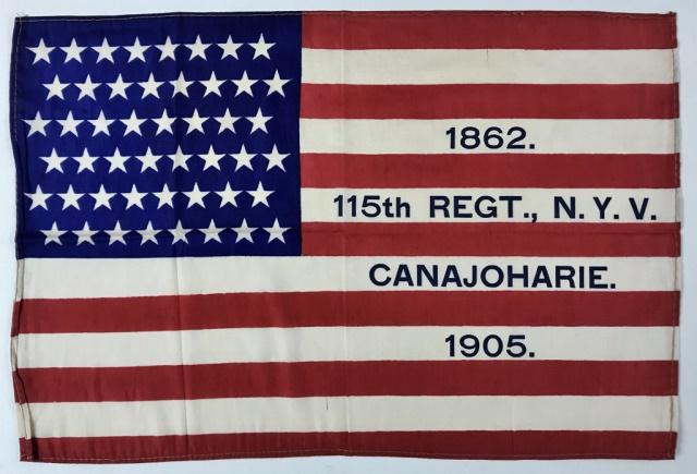 Civil War Reunion Parade Flag, 115th NY Vols 1905: Civil War Reunion Parade Flag, 115th NY Vols 1905 (1) 48 Star Flag printed on silk with text on stripes "1862. 115th Regt., N.Y.V. Canajoharie. 1905." Flag measures 8" H x 12" W. The 115th New York Vo