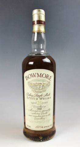 25 Year Single Malt Scotch Whiskey, 1968 Bowmore: 1968 Vintage "25 Year" Single Malt Scotch Whiskey, "BOWMORE", sealed with contents. Clear glass bottle with contents, paper label and foil sealed top. 750ml.