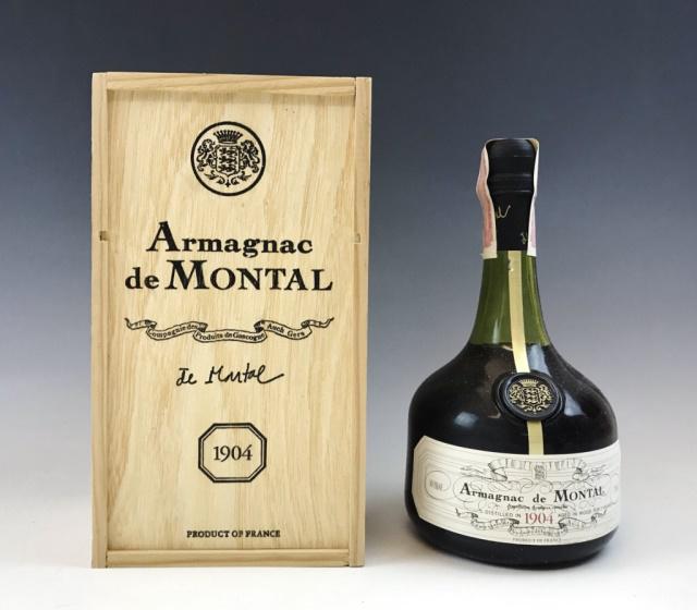 Cased French Armagnac De Montal, 1904: French Armagnac, signed "De Montal 1904". Green glass bottle, foil sealed with contents, paper label and wax seal. Bottle accompanied by fitted wooden case. 750ml.