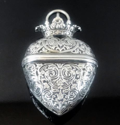 George III Sterling Silver Heart Form Locket: Antique George III English Sterling Silver Heart Form Locket. Locket with horizontal hinged lid, heavy repousse foliate decoration and suspension ring. Interior with George III English hallmarks. Lock