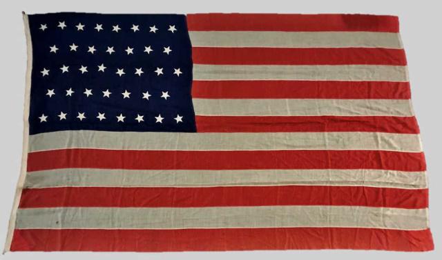 19th C. 38 Star American Flag, 1877-1890: 19th C. Thirty-Eight Star American Flag, (1865-1869). Treadle sewn multi piece wool construction with hand sewn "Dancing" style stars in 8-7-8-7-8 linear pattern. Canvas hoist with sewn in halyard wit