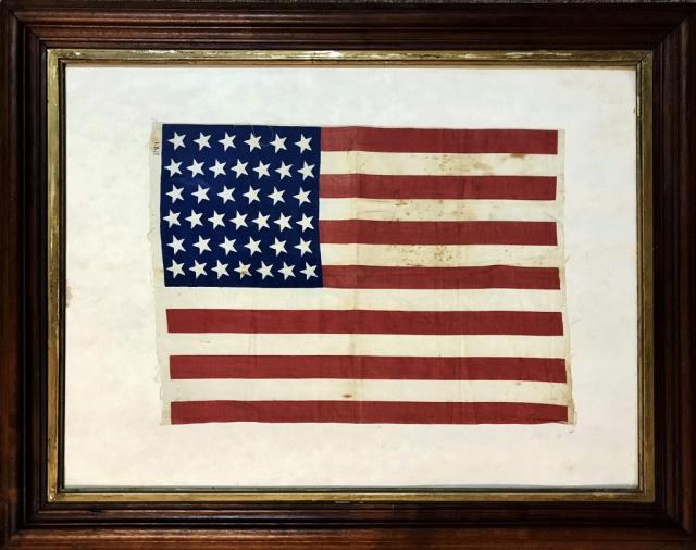 19th C. 39 Star American Parade Flag, 1889: American Thirty-Nine Star Parade Flag, Unofficial flag, (1889). Screen printed on linen with six rows of alternating six and seven canted stars in canton. Good condition, set in wooden frame under gla