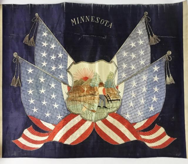 Antique Patriotic Needlework, Minnesota: Antique Patriotic Needlework. Hand made in silk thread embroidery with flags and Minnesota State Seal at Center and "MINNESOTA" at center top field. Needlework is unframed, measures: 18.75" H x 23" W.