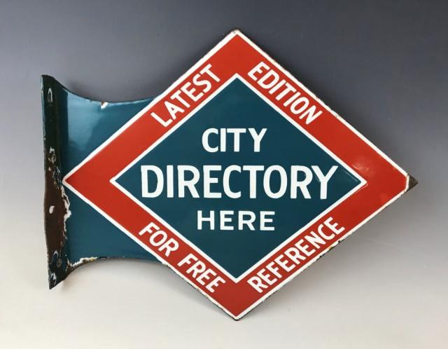 Antique Two Sided Porcelain Sign City Directory: Antique Three Color Double Sided Porcelain Flange Advertising Sign, "CITY DIRECTORY HERE LATEST EDITION FOR FREE REFERENCE". Sign with attachment flange. Excellent condition with wear, measures: 11.25