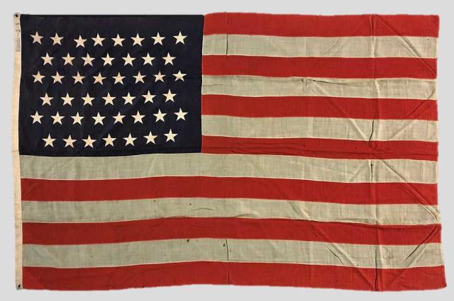 19-20th C. 45 Star American Flag 1896-1908: 19th - 20th C. Forty-Five Star American Flag, (1890-1896). Sewn multi piece wool construction with sewn applique stars in 8-7-8-7-8-7 offset linear pattern. Canvas hoist stamped "STANDARD 5 x 8" in bl