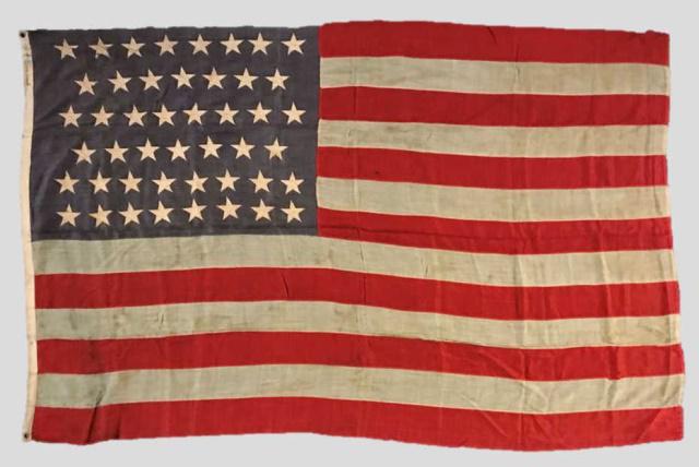 20th C. 46 Star American Flag, 1908-1912: 20th C. Forty-Six Star American Flag, (1908-1812). Sewn multi piece wool construction with sewn zigzag applique stars in 8-7-8-7-8-8 offset linear pattern. Canvas hoist with collection inventory numbe