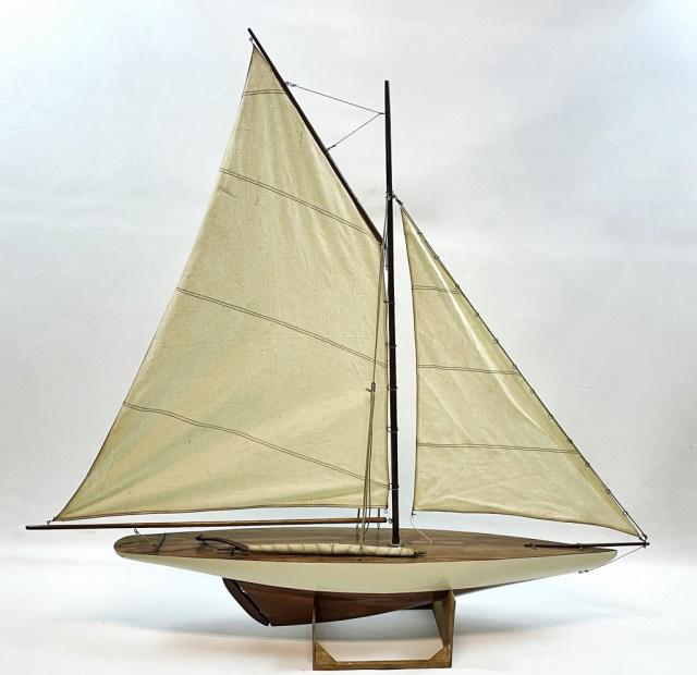 Vintage America Cup Racing Yacht Model: Vintage Model of America's Cup Racing Yacht. Accurate scale representation with mahogany hull, canvas gaff rigged mainsail and forward jib sail with rigging. Excellent condition, on stand, measures:40