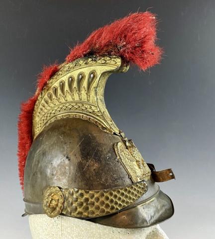 French Empire Napoleon III Cuirassiers Helmet: French Empire Napoleon III Cuirassiers Helmet. Brass helmet body with gilt decorative neoclassical brass crest with plume and chinstrap with lion head bosses. Front plate of Imperial Crowned Eagle clu