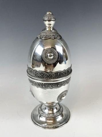 Antique Judaica, Silver Etrog, Palestine: Antique Silver Etrog, Likely Manufactured in Palestine. Crafted of silver lidded with detailed filigree and medallion decoration with finial and flared base. Excellent condition, measures: 8.75" H x 3