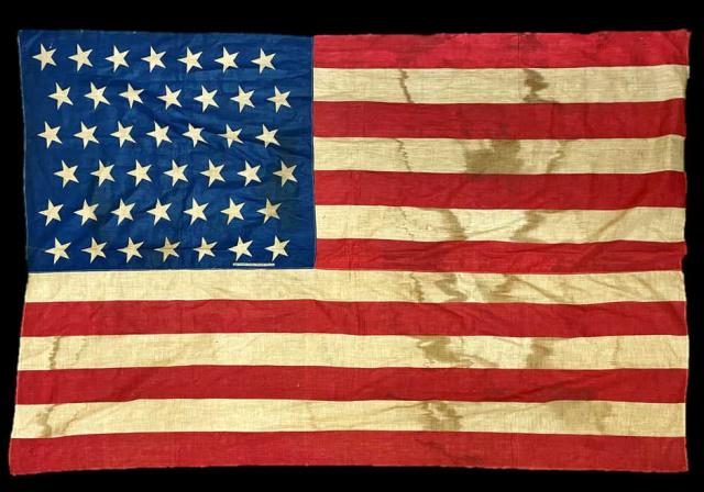 1889 42 Star American Flag: 1889 Forty-two Star American Flag. Screen printed double sided cotton, signed in field, "COTTON BUNTING. PATENT APPLIED FOR." Flag in good condition with age tone and staining, measures: 37" H x 55" W