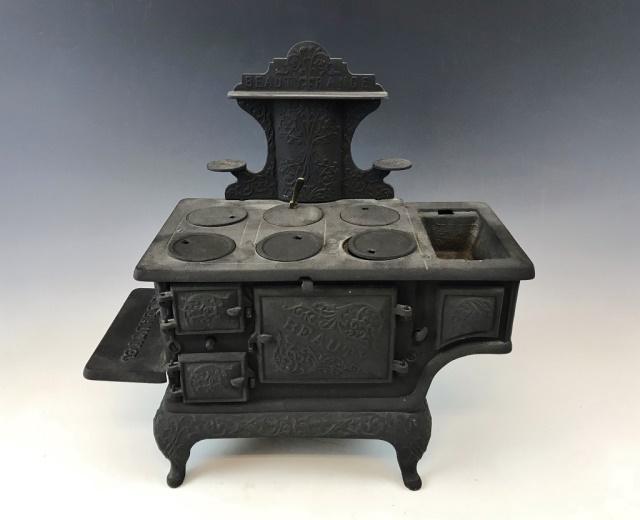 Antique Salesman Sample Stove, Beauty Range: Antique Salesman's Sample Stove, "Beauty Range". Cast iron miniature stove with accurate working hinged doors, including burner lids. Good condition missing piece, measures: 16" H x 14.75" W x 6.5" D.