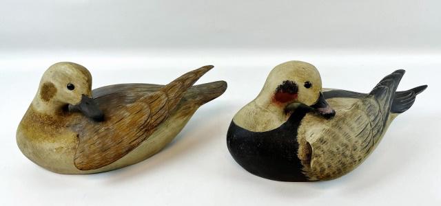 Hand Carved, Painted Duck Decoys, R Mitchell (2pc): Pair of Hand Carved and Painted Hen and Drake "Old Squaw" Duck Decoys, Signed " R. Mitchell", (Roger Mitchell, Massachusetts). Both are in preening form with raised wing, round bottom with inset glass