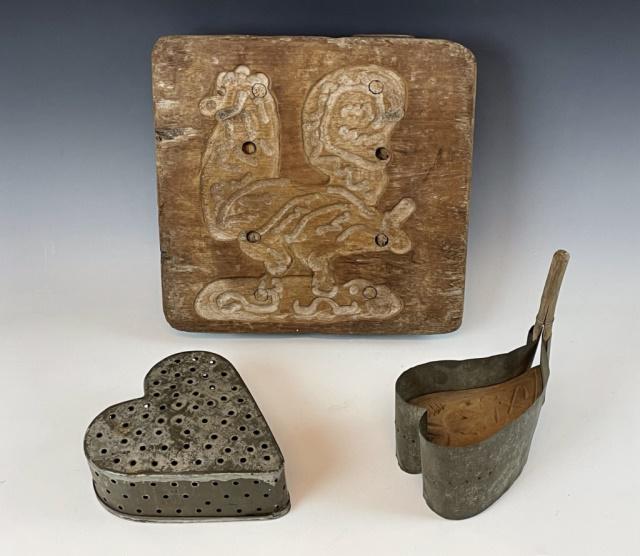 Collection, 19th C. Primitive Molds (3pc): Collection of Three Antique Baking Molds: (1) Pierced tin heart shaped mold, (1) Primitive carved wooden mold, (1) Tin and wood mold with Indian head design. Good condition with wear, largest measures