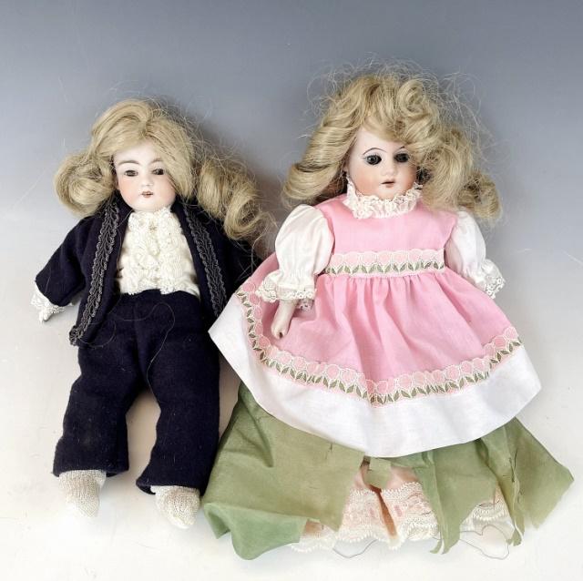 Two Continental Antique Bisque Dolls (2pc): Two Antique Continental Bisque Head Dolls, Unsigned: Female doll with natural hair with hand painted face, clothed in pink dress with petticoat. Male doll with natural hair, hand painted face, clothed