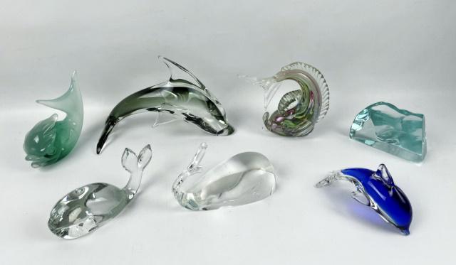 Collection Art Glass Whales, Dolphins (7pc): Collection of Seven Art Glass Dolphins and Whales. Blown glass in diverse styles and decorations. Clear glass whale signed "Steuben". Excellent condition, largest measures: 5.5" H X 8" W.