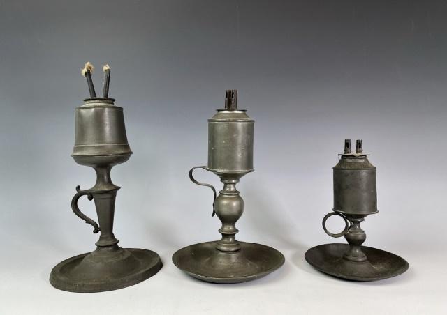 19th C. Pewter Whale Oil Lamps (3pc): Three 19th C. Pewter Whale Oil Lamps. Two double and one single flu lamps with loop handles and dish bases. One lamp signed on base, "S RUST'S PATENT NEW - YORK". Good condition, largest measures: 10"