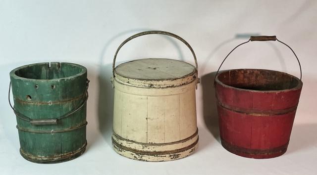 19th C. Painted Wooden Buckets, Firkin (3pc): 19th C. Primitive Painted Wooden Buckets: (1) Firkin bucket with white painted surfaces. Wooden banded slat construction with fitted cover and pegged swing arm, (1) Wooden stave red painted banded buc