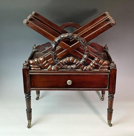 Antique English Carved Mahogany Canterbury: 19th C. English Carved Mahogany Canterbury. Sheraton style case with single drawer on turned tapered legs with brass castors. Top with carved wreath and ribbon decoration. Good condition, measures: 24