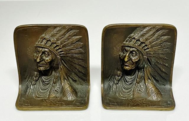 Pair of Antique Cast Bronze Bookends (2pc): Pair of Antique Cast Bronze Indian Chief Bookends. Image of Indian with Plains Culture war bonnet in relief. Reverse marked " SOLID BRONZE". Measure: 4.5" H X 4.25" W X 2.25" D.