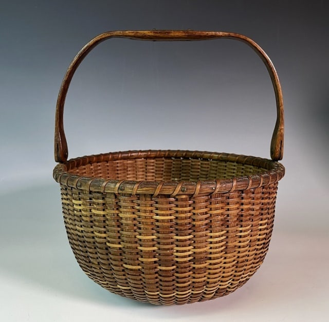 19th C. Nantucket Lightship Basket: 19th C. Nantucket Lightship Basket. Woven body with pinned carved wooden swing handle with small brass plate and turned wooden base. Good condition with light wear and patina, measures: 9.5" H (with h